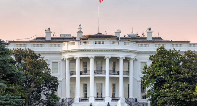 The White House in Washington DC with american flag on sunset sky at summer sunset