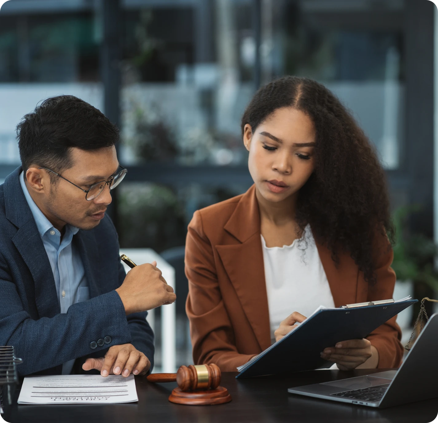 Colleagues reviewing paperwork at a desk