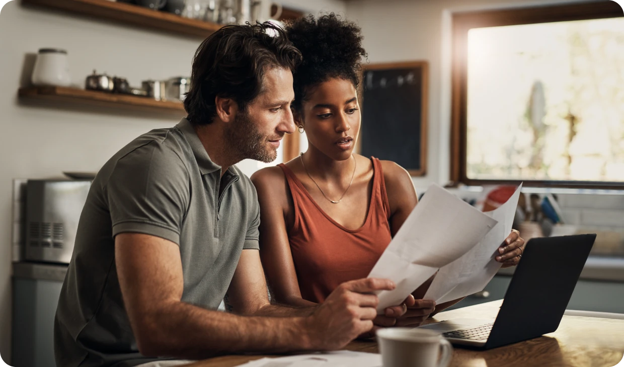 Man and woman using laptop together