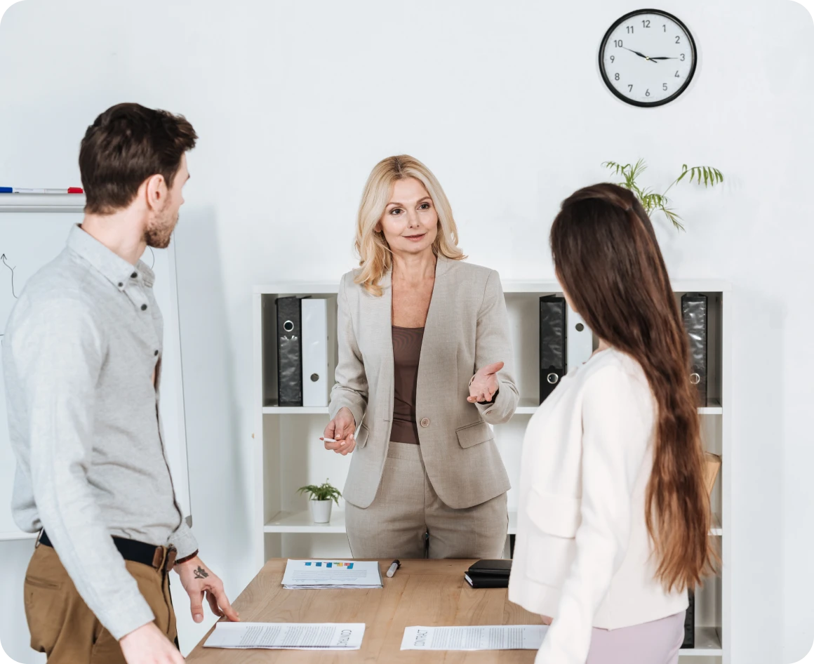 Business meeting with three people discussing
