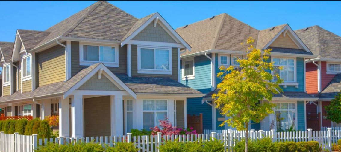 Colorful suburban houses with picket fence
