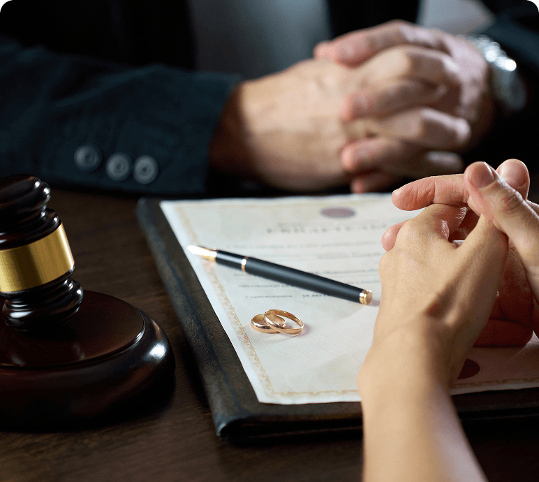 Hands with document and gavel on table.