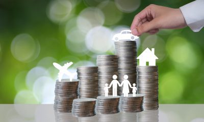 Hand arranging coins for savings plan