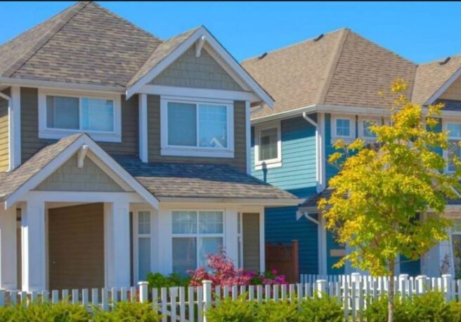 Colorful suburban houses with picket fence