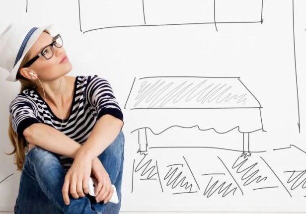 Creative woman with glasses and hat