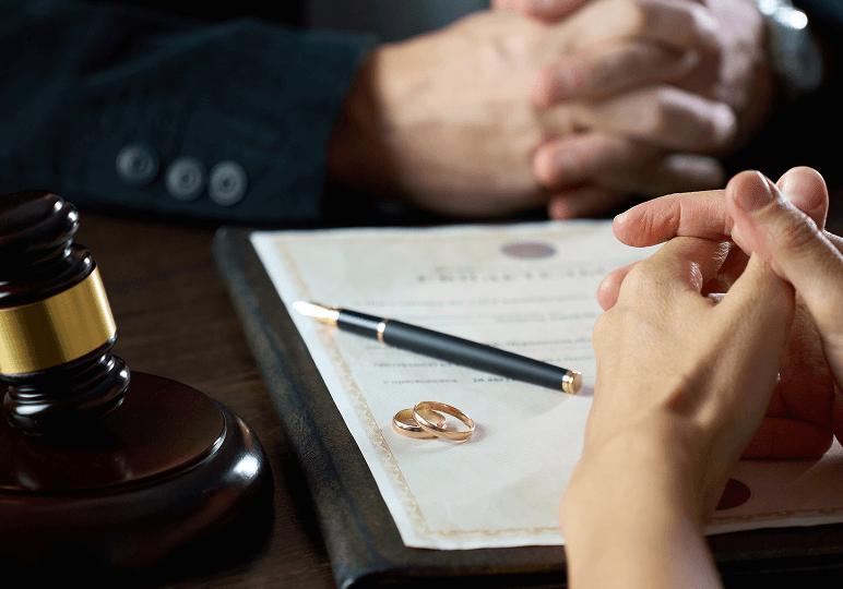 Hands with document and gavel on table.