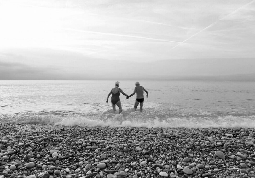 Seniors walking into the sea
