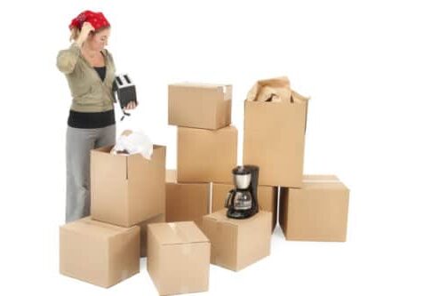 Woman packing boxes with household items